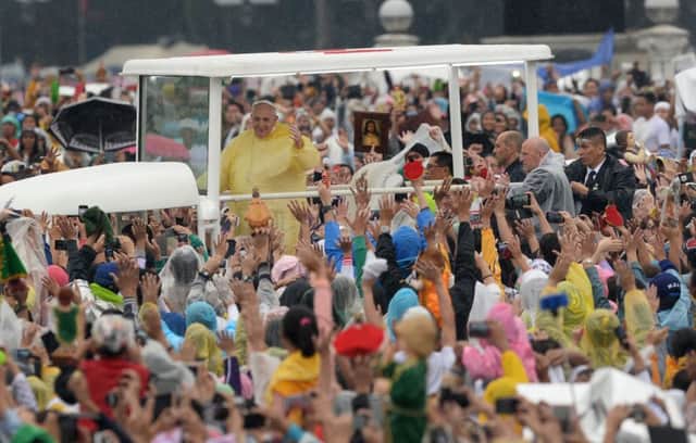 Tens of thousands of the cheering faithful were waiting for Pope Francis in Rizal Park. Picture: Getty