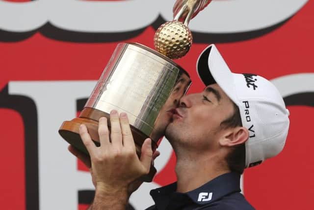 Gary Stal kisses the trophy after his win in Abu Dhabi. Picture: AP