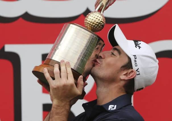 Gary Stal kisses the trophy after his win in Abu Dhabi. Picture: AP