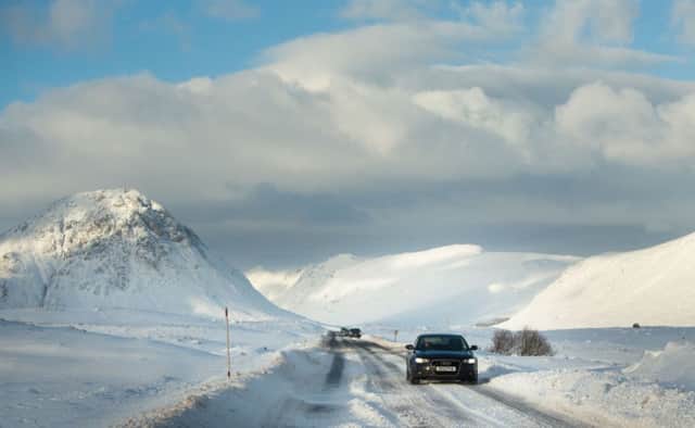 Cars make their way through snow near Rannoch Moor by Glencoe. Severe weather warnings are in place for most of the country. Picture: PA