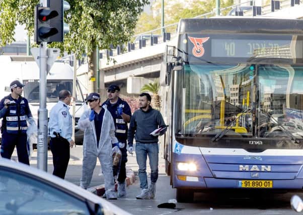 Israeli forensics officers and police at the scene of the attack in central Tel Aviv. Picture: AFP/Getty
