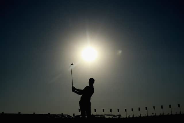 Oliver Fisher plays an iron shot on the ninth hole at a sun-kissed Qatar Masters on his way to a first-round 65 and a one-stroke lead over Rafael Cabrera-Bello. Picture: Getty