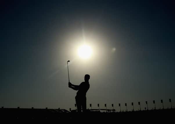 Oliver Fisher plays an iron shot on the ninth hole at a sun-kissed Qatar Masters on his way to a first-round 65 and a one-stroke lead over Rafael Cabrera-Bello. Picture: Getty