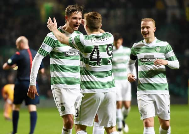 Celtic's Mikael Lustig (left) celebrates with team-mate James Forrest after scoring his side's third goal of the game. Picture: SNS