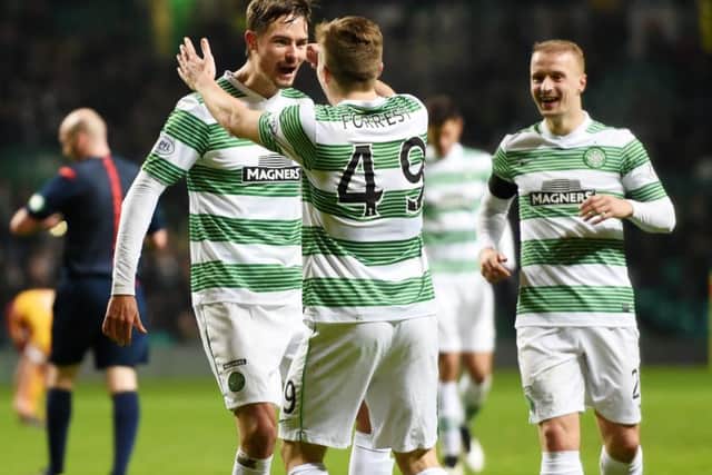 Celtic's Mikael Lustig (left) celebrates with team-mate James Forrest after scoring his side's third goal of the game. Picture: SNS