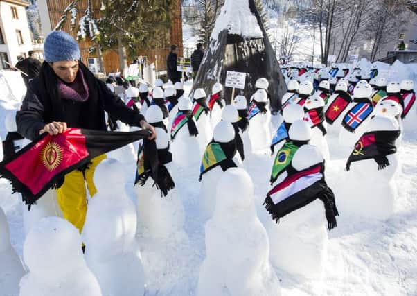 Snowmen representing countries around the world form part of the Action 2015 exhibition in Davos, Switzerland. 
Picture: PA/Keystone