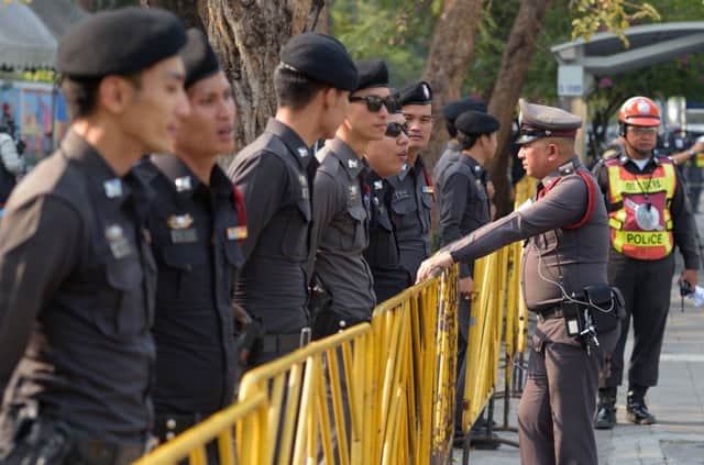 Thai police stand guard as members of the National Legislative Assembly vote on the impeachment of ousted Thai prime minister. Picture: Getty