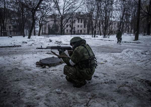 A Russianbacked separatist rebel protects a supply position in the Kievsky district near Donetsk Airport in Ukraine. Picture: AP