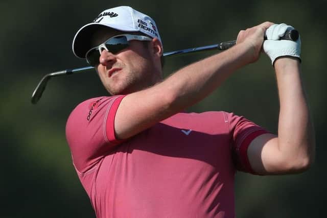 Marc Warren plays an iron shot during his round of 67 Picture: Getty