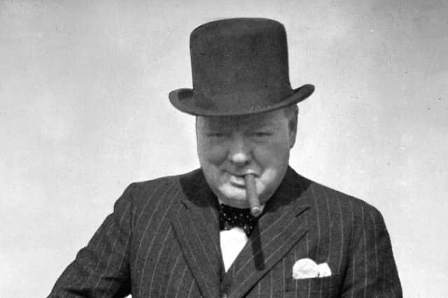 Britain's Prime Minister Winston Churchill tries a Tommy Gun during a visit to north-east England. Picture: AP