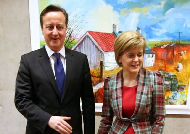 David Cameron offers Nicola Sturgeon his hand on his first trip to Edinburgh since the referendum.  Picture: Getty