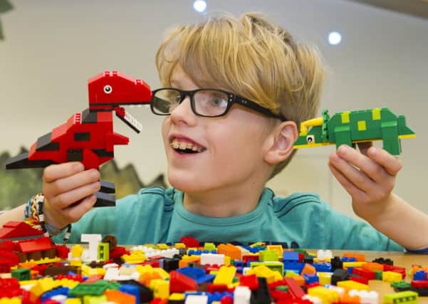 Eight-year-old Howie McNeill gets stuck in to some dinosaur building. Picture: Lesley Martin/TSPL