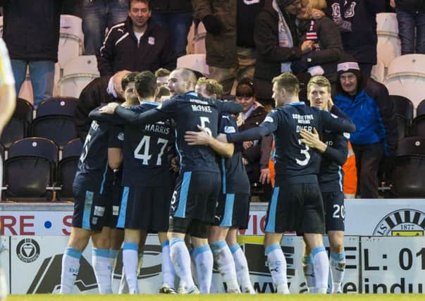 Dundee's Iain Davidson (hidden) celebrates with team mates after scoring his goal. Picture: SNS