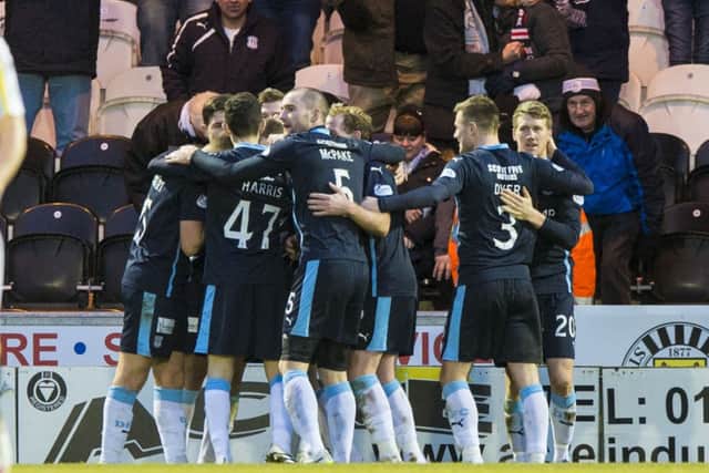 Dundee's Iain Davidson (hidden) celebrates with team mates after scoring his goal. Picture: SNS