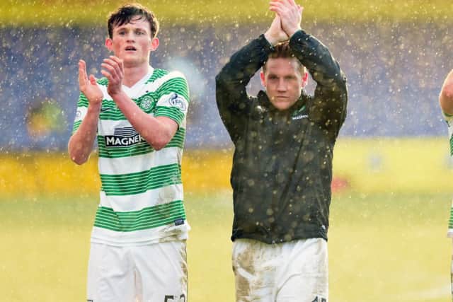 Celtic's Liam Henderson and Kris Commons applaud the fans at the end of the game. Picture: SNS