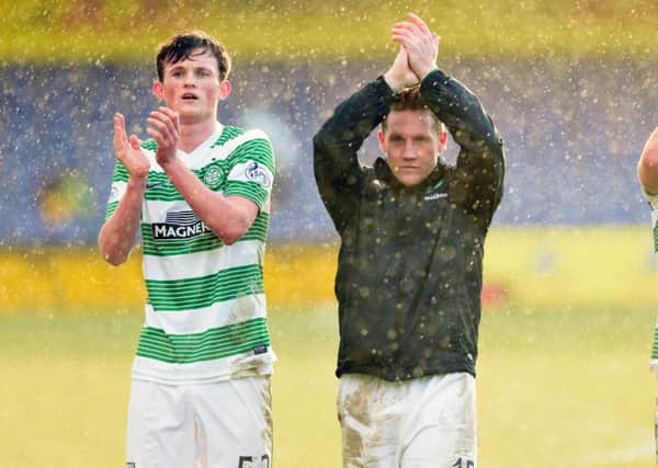 Celtic's Liam Henderson and Kris Commons applaud the fans at the end of the game. Picture: SNS