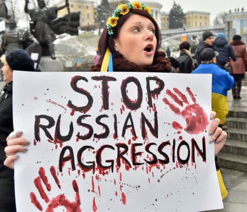 A woman joins a protest in Independence Square, Kiev, over the Mariupol attack which killed at least 30 people.  Picture: AFP/ Getty
