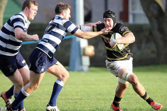 New Scotland squad member Hugh Blake fends off league leaders Heriots Stuart Edwards during Melroses victory. Picture: Gordon Fraser