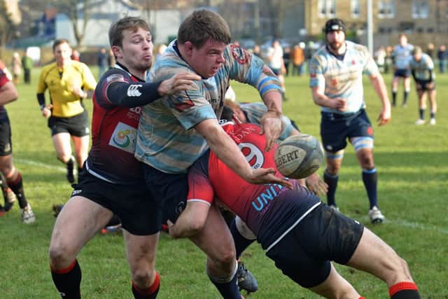 Accies prop Lewis Niven offloads in the tackles of Scott Cummings, left, and Paddy Boyer. Picture: Jon Savage