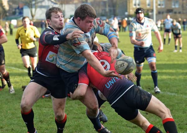 Accies prop Lewis Niven offloads in the tackles of Scott Cummings, left, and Paddy Boyer.  Picture: Jon Savage