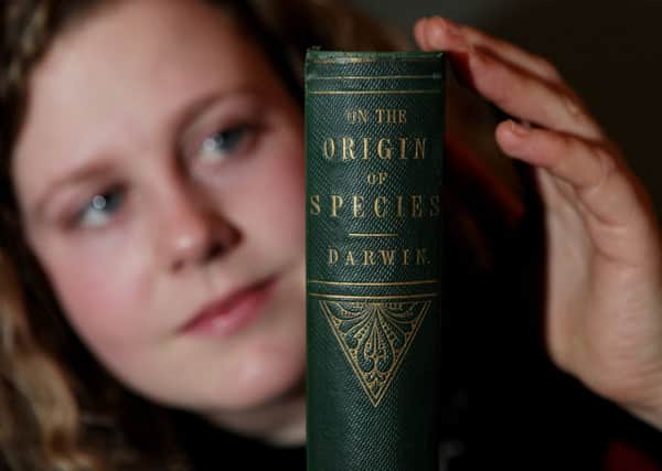 Cathy Marsden of Lyon & Turnbull with the first edition of Darwins On the Origin of Species to be auctioned this week  Picture: SWNS