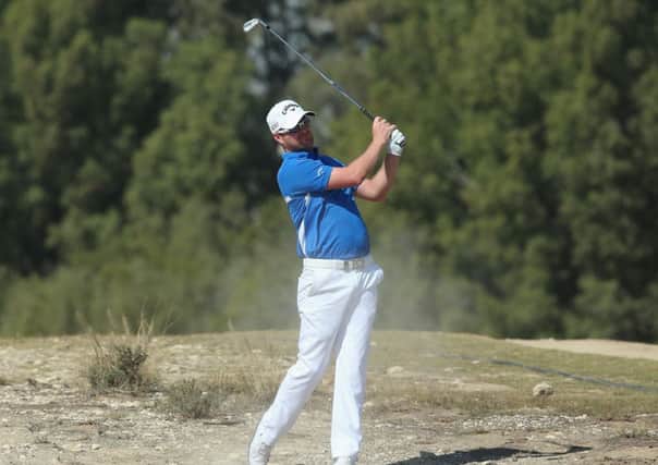 Marc Warren plays his second shot on the second hole during the final round of the Qatar Masters on Saturday Picture: Getty Images