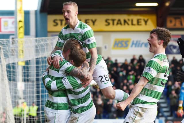 Leigh Griffiths jumps to it as the Celtic players celebrate Kris Commons deflected second-half goal in Dingwall.	Picture: SNS