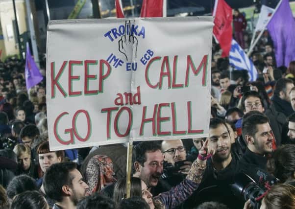 Supporters of Alexis Tsipras, leader of the left-wing Syriza party, cheer during a rally outside Athens University. Picture: Getty Images
