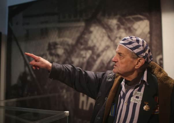 Holocaust survivor Igor Malicky, aged 90, from Cracow, pauses for thought as he tours an exhibition inside the former Auschwitz I concentration camp. Events across Scotland will mark the 70th anniversary since the camp was liberated. Picture: Getty
