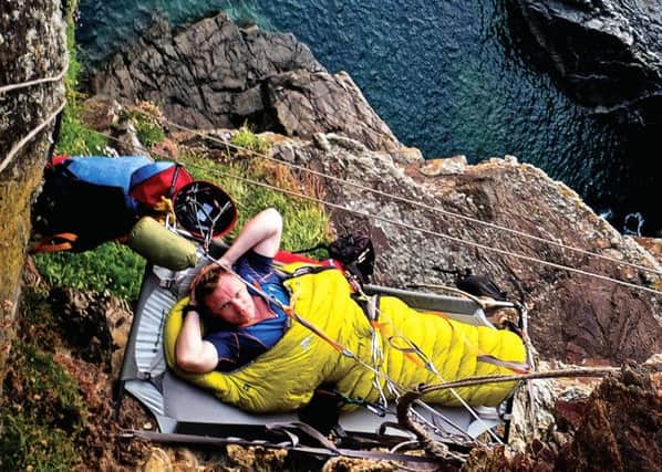 Ex-military adrenalin junkie Andy Torbet shows how to bivouac on a cliff. Picture: TSPL