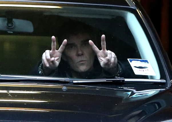 Stone Roses singer Ian Brown is driven away from court after giving evidence against his former teacher. Pictures: Peter Byrne/PA Wire