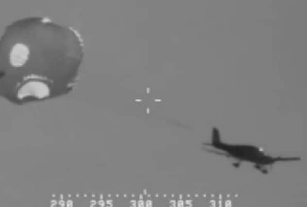 The plane and parachute seen in a screenshot from the coast guard. Picture: Contributed