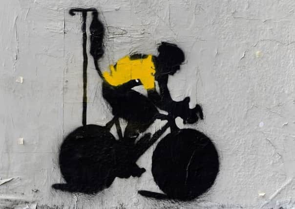 Graffiti depicts Lance Armstrong in the yellow jersey hooked up to an IV. Picture: Getty