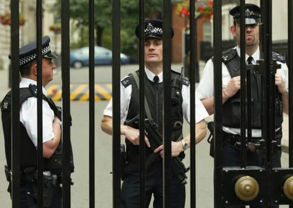 Police officers guard Downing Street. New figures have revealed that 80 officers charged with guarding the Queen, the Prime Minister and top politicians have been charged with misconduct. Picture: AP
