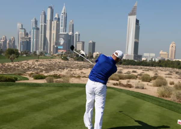Stephen Gallacher drives towards the spectacular Dubai skyline during the opening round.  Picture: AFP/Getty