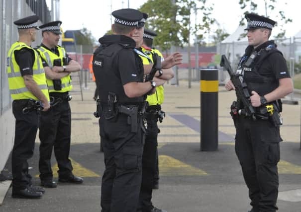 The sight of officers carrying handguns and Taser stun guns on our streets gave rise to considerable disquiet. Picture: TSPL