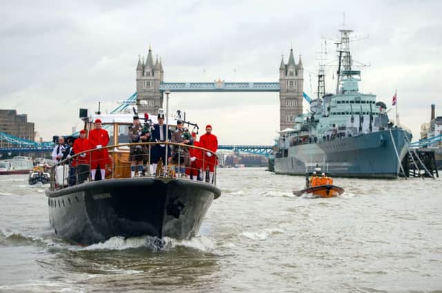 The Havengore boat sails past Tower Bridge and HMS Belfast during a re-enactment of Winston Churchill's funeral. Picture: Getty