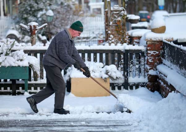 A man clears snow from his drive way in the village of Abington, South Lanarkshire. Picture: Hemedia