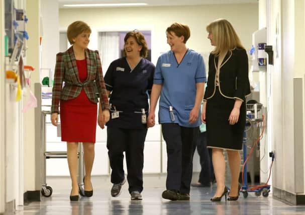 Sturgeon with specialist nurses Paola Niven and Karen Kose and Health Minister Shona Robison at Ninewells Hospital in Dundee. Picture Andrew Milligan/PA