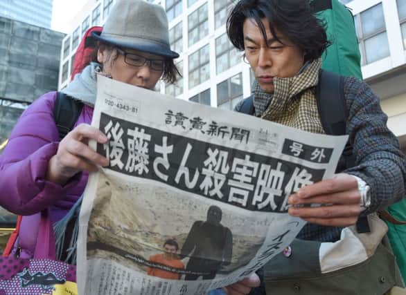 People read an extra edition newspaper reporting on the death of Japanese journalist Kenji Goto. Picture: Getty
