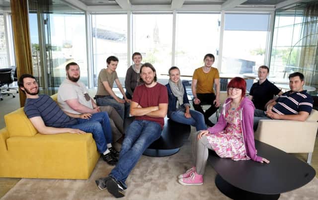 John Peebles, seated centre, and the Administrate team. The fresh funding will help it expand its presence in North America