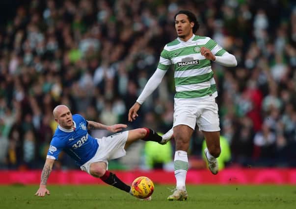 Virgil van Dijk breaks clear of Nicky Law during yesterday's cup final - and the Dutchman expects to stay a Celtic player. Picture: Getty