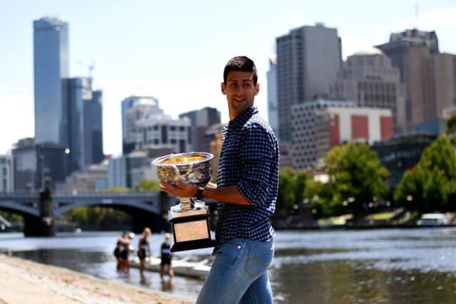 Champion Novak Djokovic shows off his trophy in downtown Melbourne. Picture: Getty