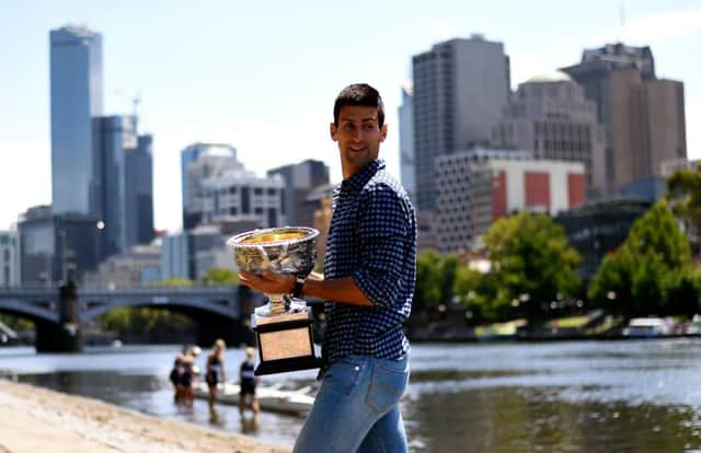 Champion Novak Djokovic shows off his trophy in downtown Melbourne. Picture: Getty