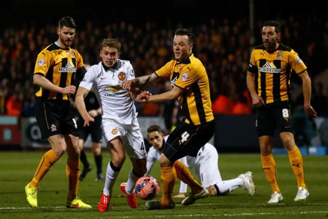 Manchester Uniteds James Wilson battles for the ball with Josh Coulson. Picture: Getty