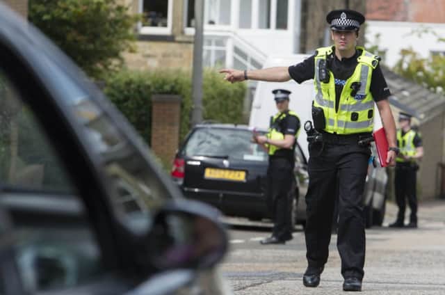 Police carry out inquiries in Morningside following the attack. Picture: Steven Scott Taylor