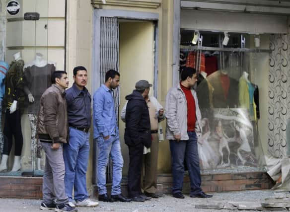 Egyptians inspect the damage caused by a flash-bang grenade when it exploded in Cairo yesterday. Picture: AP