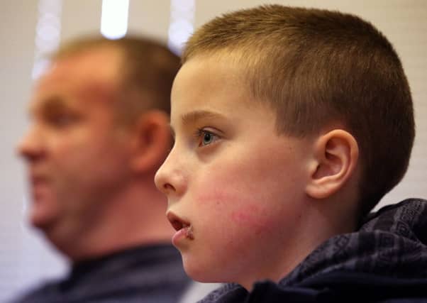Kieran Duffy with his father Robert at London Road Police Station in Glasgow. Picture: PA