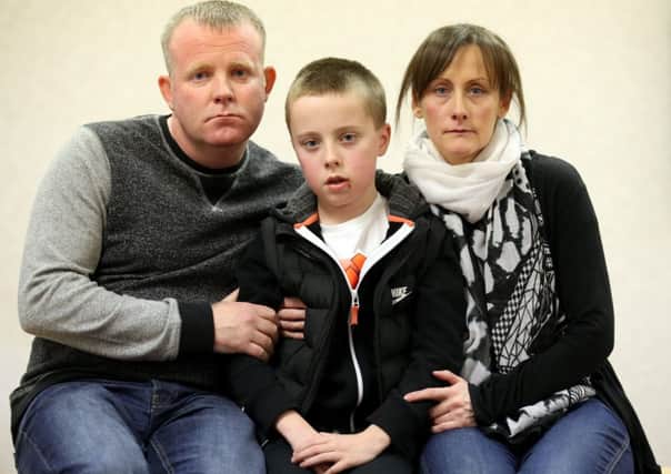 Kieran Duffy with his parents Robert and Amanda, during an appeal for information. Picture: Hemedia