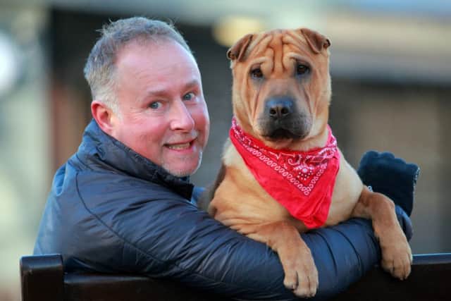 Kai the dog meets his new owner Ian Russell. Picture: Hemedia